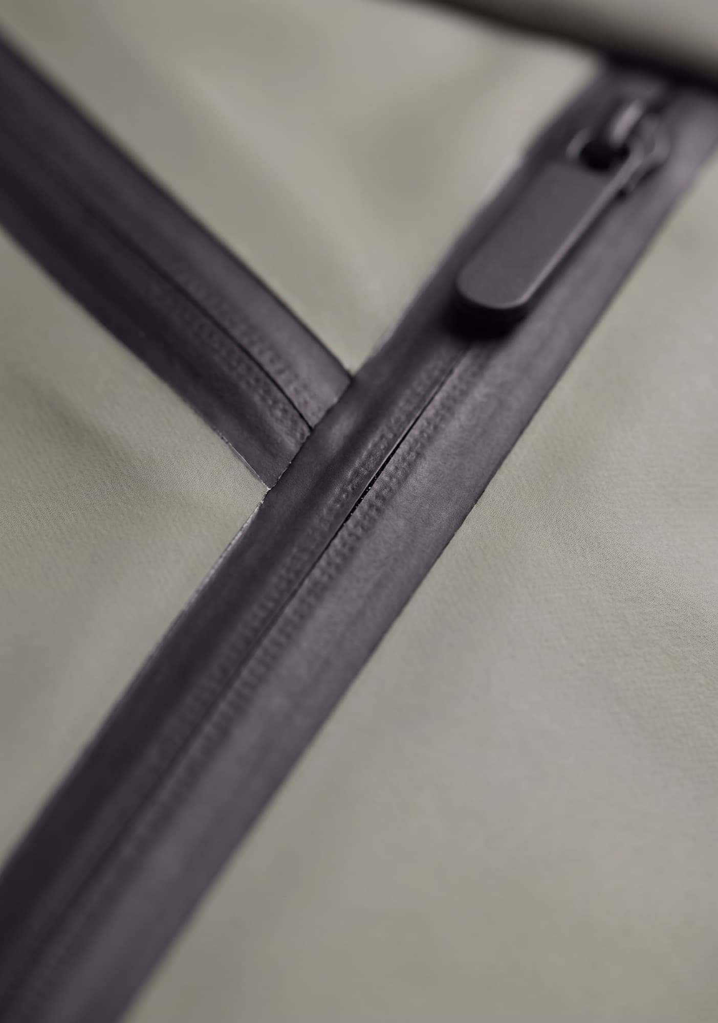 A sealed waterproof zip closed on matte shell fabric