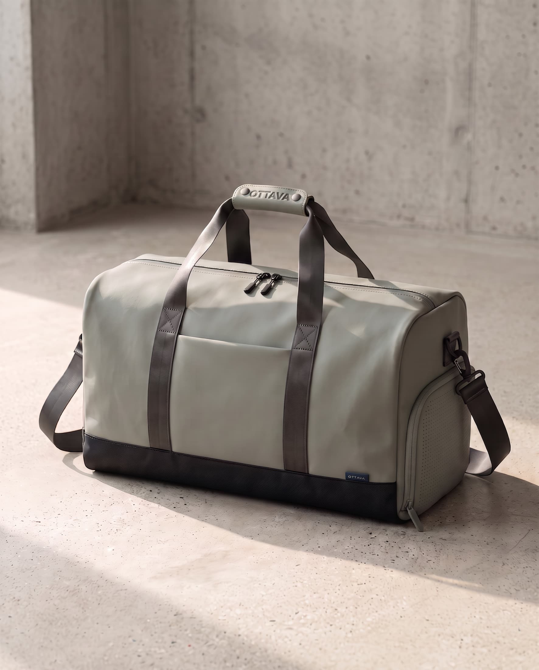 OTTAVA Duffel 40 in Fog Sage on a concrete floor in morning light