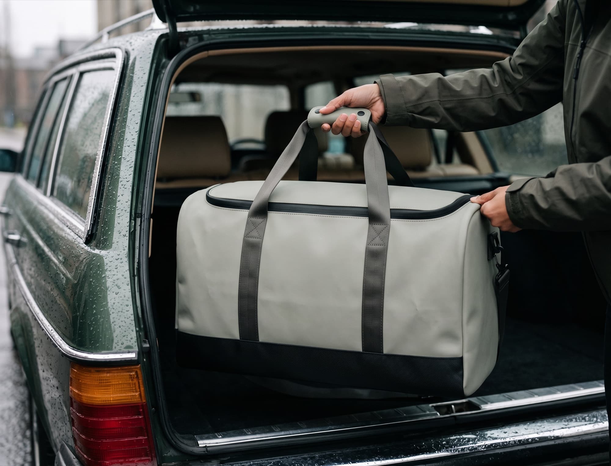 Loading the duffel into a car boot in the rain