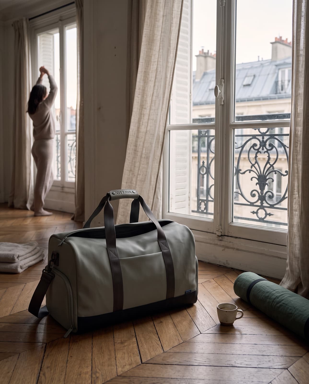 Duffel 40 on a herringbone floor by tall Paris windows at dawn